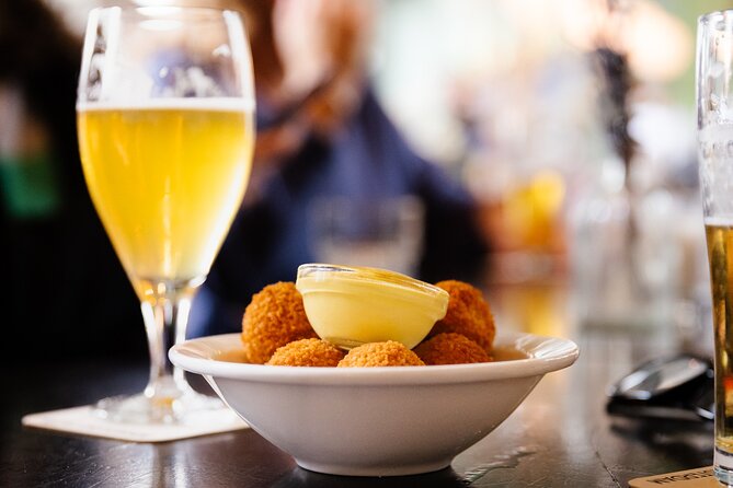 Amsterdam High-End Dutch Food & History Tour - Up to 8 guests - Herring, fried cod, and smoked eel at the fish shop