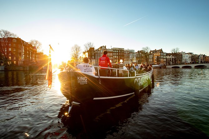 Amsterdam Open Boat Cruise with Live Guide and Two Drinks - The old center and its complicated stories