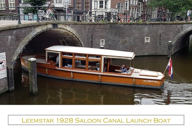 Amsterdam small-group canal cruise in 1920s saloon boat - Covered seating, blankets, and changing weather