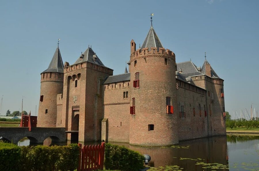 From Amsterdam: Muiderslot and De Haar Castle Tour - Entering Muiderslot, the medieval stronghold