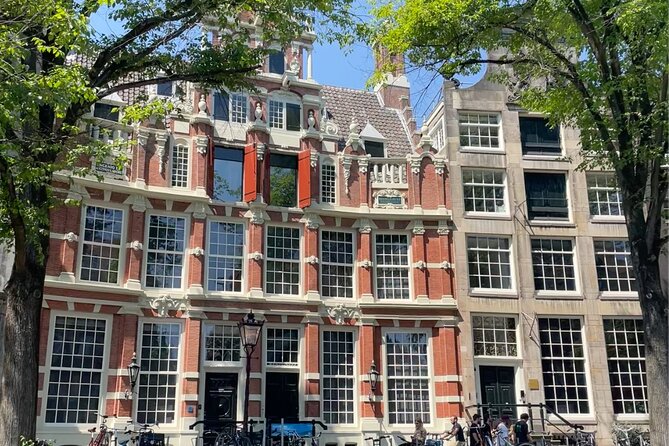 Private Walking Tour of Amsterdam - Clubbing, statues, and an old city gate