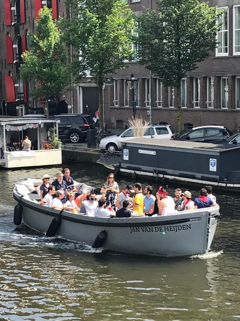 Visit Amsterdam by Boat with a French Guide (french) - A small boat with room for conversation