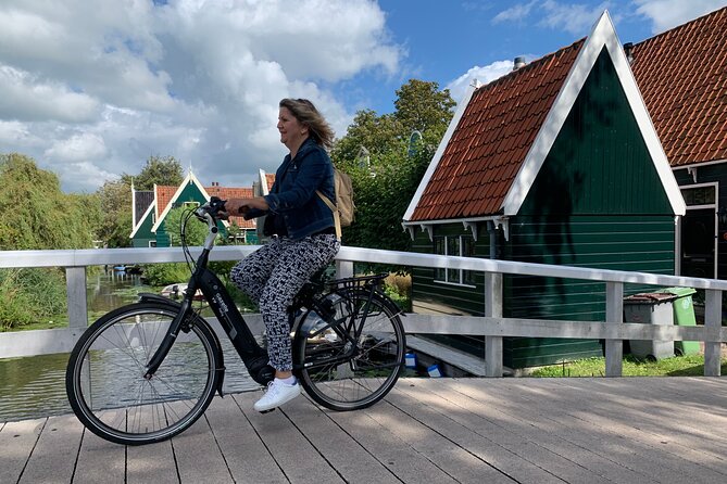 Visit Amsterdam Countryside with windmills by bike - Cycling across wet meadows and dikes